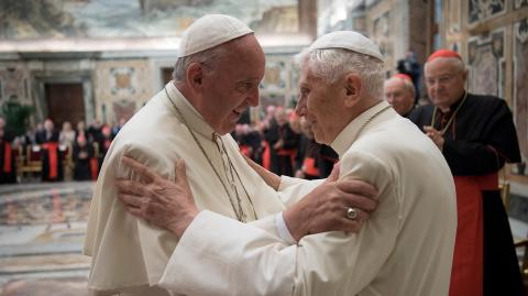 FILE PHOTO: Former pope Benedict is greeted by Pope Francis during a ceremony to mark his 65th anniversary of ordination to the priesthood at the Vatican