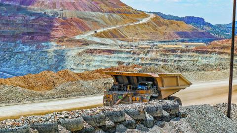 Silver City, New Mexico USA - July 30, 2019: Ore hauling truck in the Santa Rita Chino copper mine carrying hundreds of tons of raw material from the open pit excavation.