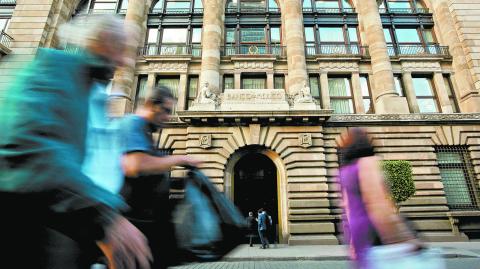 FILE PHOTO: People walk past the building of Mexico