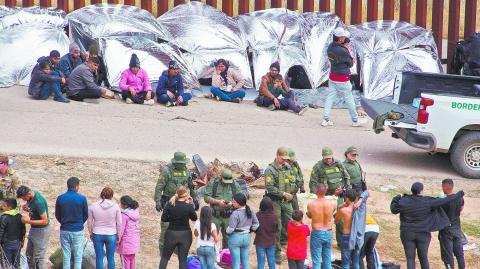 Migrants gather along the U.S.-Mexico border before the lifting of Title 42, as seen from Tijuana