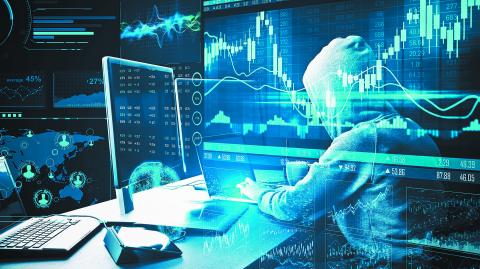 Hacker using computer with stock charts and  business statistics hologram. Hacking and cyber attack concept.