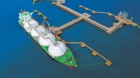 LNG (Liquified Natural Gas) tanker anchored in Gas terminal gas tanks for storage. Oil Crude Gas Tanker Ship. LPG at Tanker Bay Petroleum Chemical or Methane freighter export import transportation