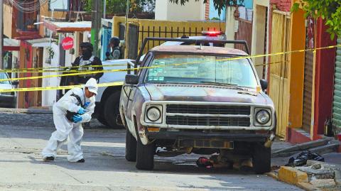 Forensic technicians work at crime scene, in Cuernavaca