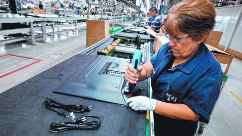 FILE PHOTO: An employee works at an LED TV assembly line at a factory that exports to the U.S. in Ciudad Juarez