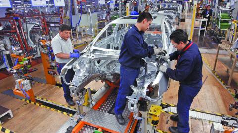 Employees work on the assembly line on the Jetta Bicentennial at the Volkswagen automobile manufacturing factory in Puebla