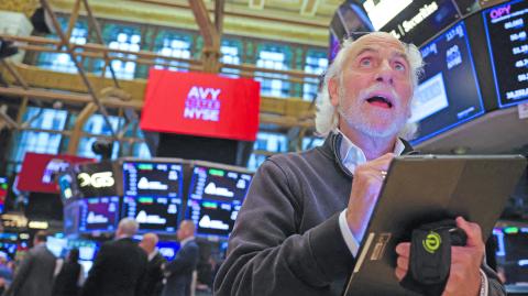 FILE PHOTO: A trader works on the trading floor at The New York Stock Exchange (NYSE) following the Federal Reserve rate announcement, in New York City, U.S., September 18, 2024. REUTERS/Andrew Kelly/File Photo