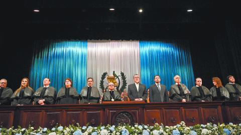 The new President of the Supreme Court of Justice, Carlos Lucero (5th-L), and Guatemalan President Bernardo Arevalo (5th-R) are seen during a ceremony where new judges take office at the Teatro Nacional Miguel Angel Asturias in Guatemala City on October 13, 2024. The new judges of the Supreme Court of Guatemala take office this Sunday amid doubts about their probity, after a selection process questioned for its lack of transparency. (Photo by JOHAN ORDONEZ / AFP)