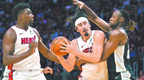 Oct 15, 2024; Miami, Florida, USA; Miami Heat guard Jaime Jaquez Jr. (11) drives to the basket against San Antonio Spurs center Charles Bassey (28) during the third quarter at Kaseya Center. Mandatory Credit: Sam Navarro-Imagn Images