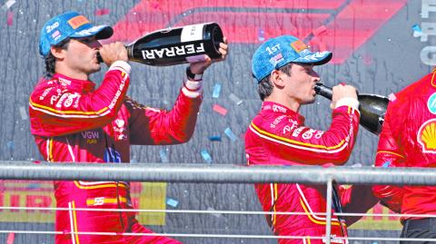 Oct 20, 2024; Austin, Texas, USA; Scuderia Ferrari driver Carlos Sainz (left) of Team Spain and Scuderia Ferrari driver Charles Leclerc (right) of Team Monaco drink champagne on the podium after the 2024 Formula One US Grand Prix at Circuit of the Americas. Mandatory Credit: Jerome Miron-Imagn Images