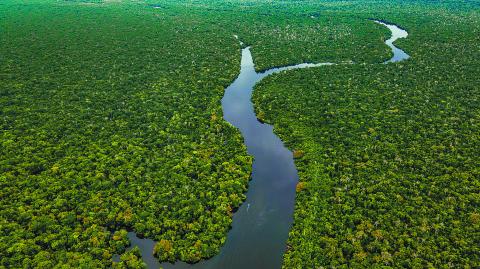 Aerial view of the Amazon River winding through lush greenery in Leticia, Colombia