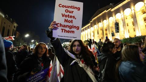 Georgian opposition supporters rally to protest results of the parliamentary elections that showed a win for the ruling Georgian Dream party, outside the parliament building in central Tbilisi on October 28, 2024. (Photo by Giorgi ARJEVANIDZE / AFP)