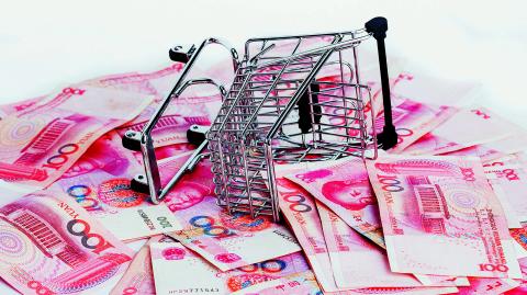 Shopping trolley full of Yuan - currency. Symbolic example of spending money in shops, or advantageous purchase in the shopping center. Yuan notes from China's currency. Chinese banknotes