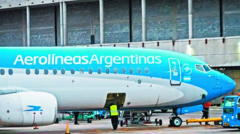 Buenos Aires, Argentina - Aug 10 2024: The staff are seen doing final inspections on an Aerolineas Argentinas aircraft.