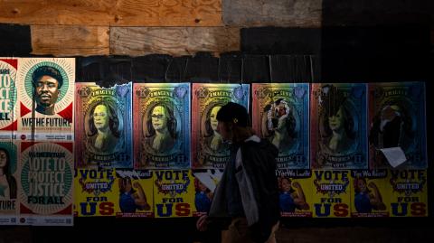 PHILADELPHIA, PENNSYLVANIA - NOVEMBER 04: People walk past posters campaigning for Democratic presidential nominee, U.S. Vice President Kamala Harris are seen on a wall along twelfth street on November 04, 2024 in Philadelphia, Pennsylvania. With polls predicting one of the tightest presidential elections in modern U.S. history, candidates Vice President Kamala Harris and former President Donald Trump are focusing on key battleground states on the eve of the election.. (Kent Nishimura/Getty Images) (Photo by Kent Nishimura / GETTY IMAGES NORTH AMERICA / Getty Images via AFP)