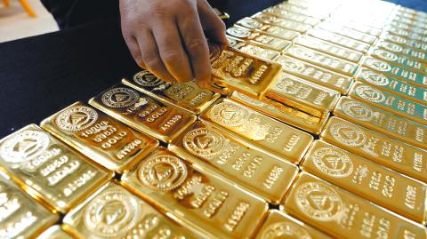 A employee works on 1 kg. gold bars in Ahlatci Metal Refinery in the central Anatolian city of Corum, Turkey, May 11, 2017. Picture taken May 11, 2017. REUTERS/Umit Bektas