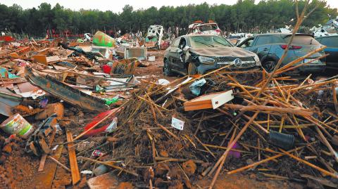 Nearly a month after severe flooding, damaged cars are placed together on the outskirts of the town in Paiporta, Valencia, Spain, November 28, 2024. REUTERS/Eva Manez