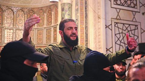 The leader of Syria's Islamist Hayat Tahrir al-Sham (HTS) group that headed a lightning rebel offensive snatching Damascus from government control, Abu Mohammed al-Jolani, address a crowd at the capital's landmark Umayyad Mosque on December 8, 2024. - Jolani, now using his real name Ahmed al-Sharaa, gave a speech as the crowd chanted "Allahu akbar (God is greatest)," a video shared by the rebels on their Telegram channel showed. (Photo by Aref TAMMAWI / AFP)