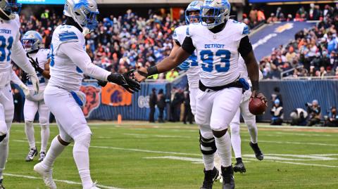 Dec 22, 2024; Chicago, Illinois, USA; Detroit Lions defensive end Josh Paschal (93) celebrates his fumble recovery against the Chicago Bears during the first quarter at Soldier Field. Mandatory Credit: Daniel Bartel-Imagn Images