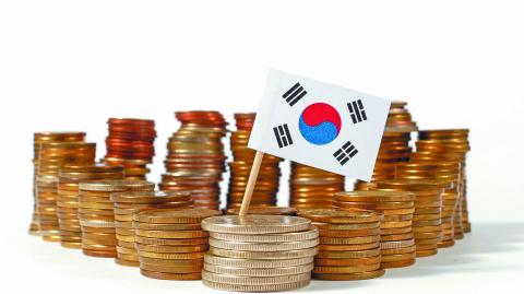 South Korea flag waving with stack of money coins