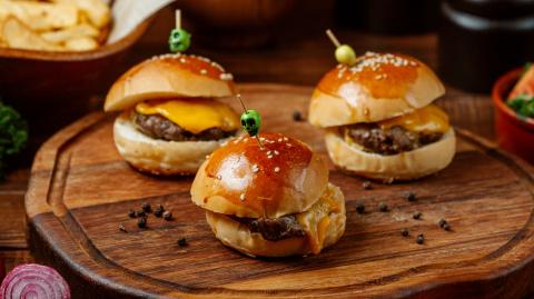 mini burgers on wooden board