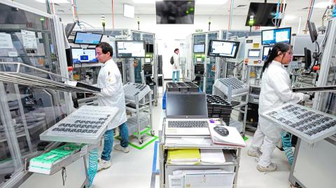 Workers assemble electronic car keys at a manufacturing plant in Tlajomulco de Zuniga, Jalisco State, Mexico, on February 20, 2025. The production of key fobs used by millions each day is an example of the benefits of the USMCA free trade agreement between the United States, Canada, and Mexico, which has simplified manufacturing and supply chains. The small, handheld remote controls are assembled in Mexico, but they cross borders in North America several times before being finished, like countless other auto parts and products. (Photo by ULISES RUIZ / AFP)
