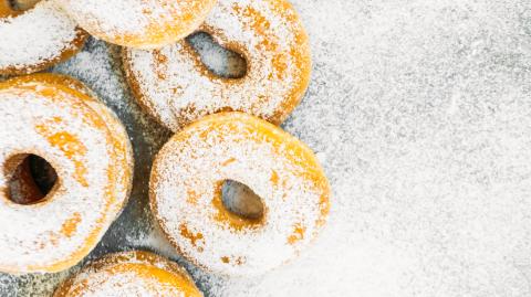 Sweet dessert with many donut on top with sugar icing - Unhealthy food style