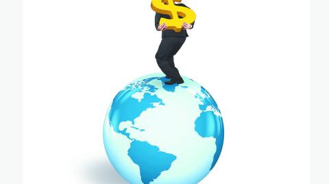 Man carrying gold dollar sign standing on globe with world map, isolated on white background.