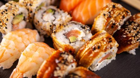 Close up of delicious fresh sushi on black plate