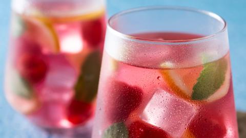 Raspberry lemonade drink on blue background