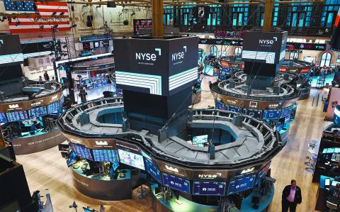 Traders work on the trading floor at the New York Stock Exchange (NYSE) in New York City