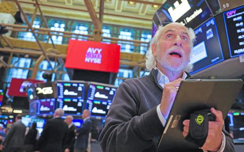 FILE PHOTO: A trader works on the trading floor at The New York Stock Exchange (NYSE) following the Federal Reserve rate announcement, in New York City, U.S., September 18, 2024. REUTERS/Andrew Kelly/File Photo