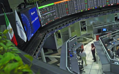 Employees interact as a ticker displays stock exchange data at Mexico's stock exchange, in Mexico City, Mexico June 1, 2021. REUTERS/Toya Sardo Jordan