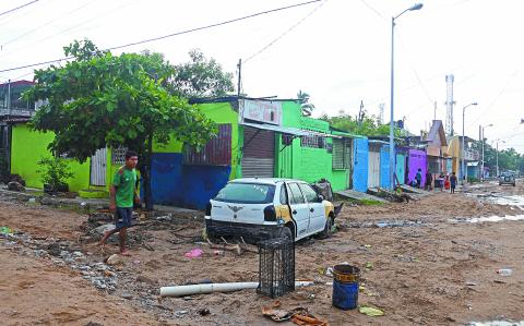 A damaged car remains on a muddy street following Hurricane John in Acapulco, Guerrero state, Mexico, on October 2, 2024. - John made landfall on September 24 as a Category 3 hurricane before churning along the coast for several days and striking land again as a tropical storm. (Photo by Francisco ROBLES / AFP)