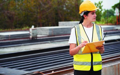 Portrait Hispanic latin engineer woman use clipboard checking precast cement at precast cement outdoor factory