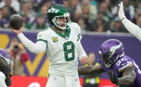 Oct 6, 2024; London, United Kingdom; New York Jets quarterback Aaron Rodgers (8) throws the ball under pressure from Minnesota Vikings center Garrett Bradbury (56) in the second half at Tottenham Hotspur Stadium. Mandatory Credit: Kirby Lee-Imagn Images