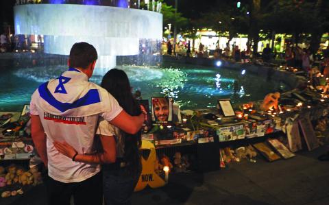 People gather to mark the first anniversary of the October 7, 2023 attacks, in the Israeli coastal city of Tel Aviv on October 7, 2024. - Israel marked the first anniversary of the deadliest attack in its history, with Prime Minister Benjamin Netanyahu saying the Gaza and Lebanon wars would ensure the violence it endured last October 7 could never be repeated. (Photo by GIL COHEN-MAGEN / AFP)