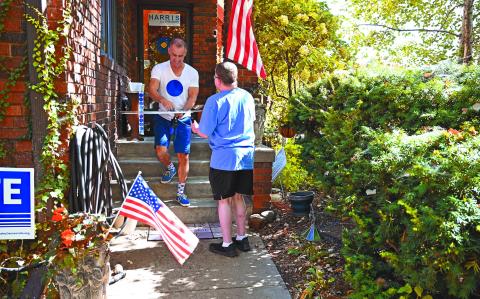 Jason Brown gives a neighbor a handcrafted political sign featuring a simple blue dot, at his home in Omaha, Nebraska, on September 30, 2024. - Nestled deep in America's heartland, Nebraska is best known for corn, cattle and college football -- not usually for its elections. That could be about to dramatically change.
A strange quirk of the devoutly Republican state's constitution essentially gives Omaha -- the largest city -- its own distinct and powerful vote for the next US president, in a race that remains too close to call just one month out.
In the far-from-impossible scenario that Kamala Harris and Donald Trump are otherwise tied in the Electoral College that determines the White House's next occupant, this tiny Democratic-leaning "blue dot" of 650,000 people could have the final say. (Photo by Alex WROBLEWSKI / AFP)