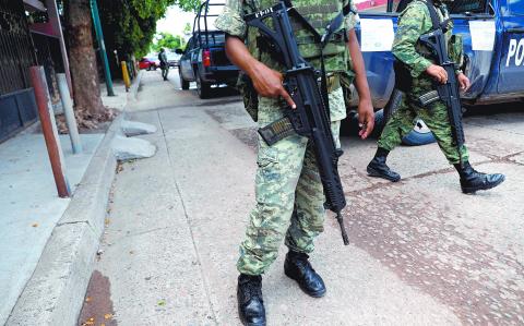 Soldiers stand guard near a checkpoint along a street in Culiacan, Mexico, September 9, 2018, REUTERS/Henry Romero