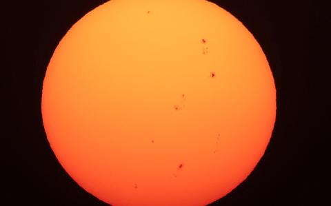 The sun and its sunspots are pictured over Kuwait City on August 24, 2024. (Photo by YASSER AL-ZAYYAT / AFP)