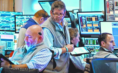 FILE PHOTO: Traders work on the floor at the New York Stock Exchange (NYSE) in New York City, U.S., September 19, 2024.  REUTERS/Brendan McDermid/File Photo