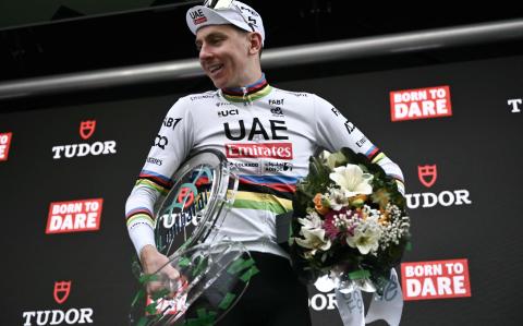 UAE Team Emirates team's Slovenian rider Tadej Pogacar celebrates his victory with the trophy on the podium after winning the 118th edition of the Giro di Lombardia (Tour of Lombardy), a 252km cycling race from Bergamo to Como on October 12, 2024. (Photo by Marco BERTORELLO / AFP)