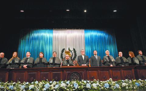 The new President of the Supreme Court of Justice, Carlos Lucero (5th-L), and Guatemalan President Bernardo Arevalo (5th-R) are seen during a ceremony where new judges take office at the Teatro Nacional Miguel Angel Asturias in Guatemala City on October 13, 2024. The new judges of the Supreme Court of Guatemala take office this Sunday amid doubts about their probity, after a selection process questioned for its lack of transparency. (Photo by JOHAN ORDONEZ / AFP)