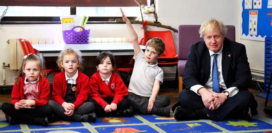 El Secretario de Relaciones Exteriores Boris Johnson se sienta con los alumnos durante una visita a la Academia Primaria de la Iglesia de Inglaterra de St. Leonard en Hastings, marzo de 2018. 