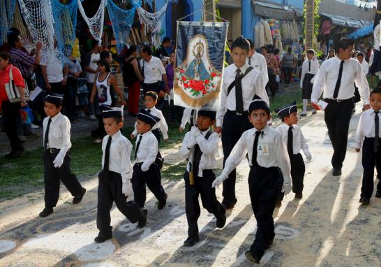 Una escolta de niños acompaña y custodia a la imagen en su recorrido ritual.