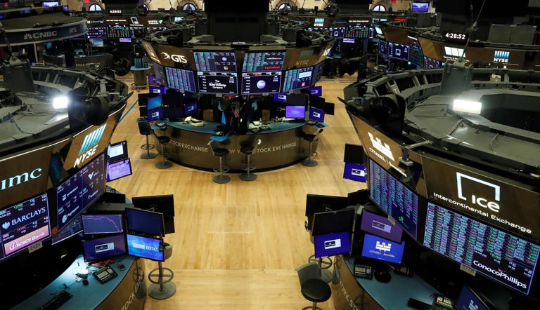 FILE PHOTO: Floor traders work space is seen on the trading floor after the closing bell, following traders positive for Coronavirus disease (COVID-19), at the NYSE in New York