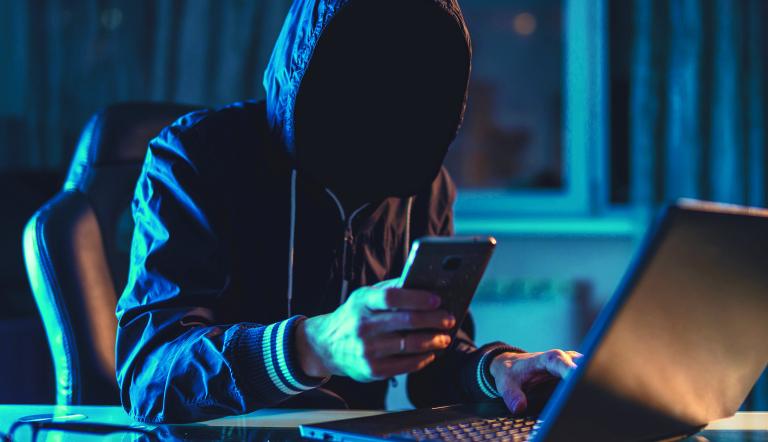 Anonymous,Hacker,Programmer,Uses,A,Laptop,To,Hack,The,System
