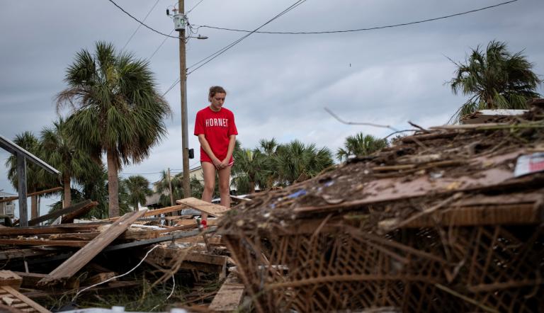 Piper Wagenman se encuentra entre los escombros de la casa de playa de su familia, luego del huracán Helene en Horseshoe Beach, Florida.