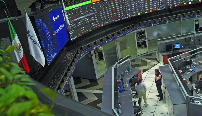 Employees interact as a ticker displays stock exchange data at Mexico's stock exchange, in Mexico City, Mexico June 1, 2021. REUTERS/Toya Sardo Jordan