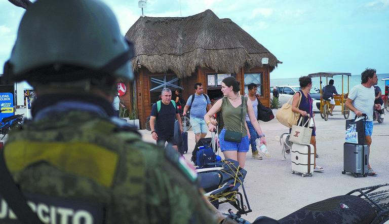 A member of the Mexican Army watches while residents and tourists heed a voluntary evacuation call as Hurricane Milton advances, on the island of Holbox, Mexico, October 7, 2024. REUTERS/Paola Chiomante