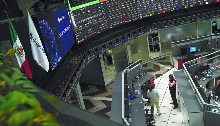 Employees interact as a ticker displays stock exchange data at Mexico's stock exchange, in Mexico City, Mexico June 1, 2021. REUTERS/Toya Sardo Jordan